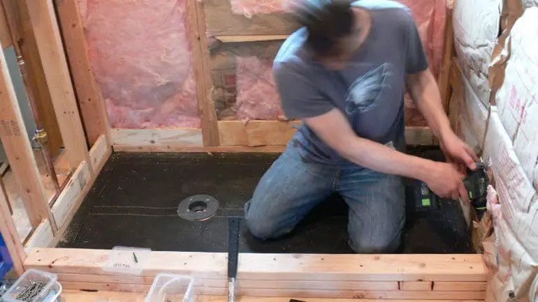 how to install a shower base on a wooden floor
